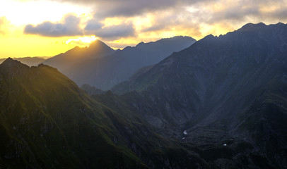 Sunrise on Fagaras high mountain ridge. Romanian mountain landscape with high peaks over 2200m