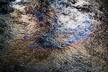 Oil stain on Asphalt road after rain