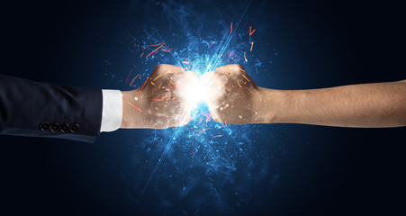 Fototapeta na wymiar Two hands fighting with light, glow, spark and smoke concept