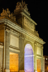 the impressive puerta de Toledo (city gate to Toledo) illuminated during evening. Madrid attracts...