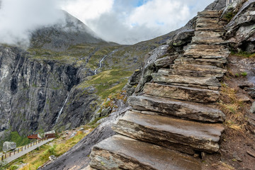 Fototapeta na wymiar Stone stairs on trekking path in Norway mountains near Trollstigen viewing point