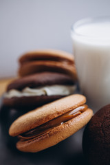 Close up Traditional chocolate and Pumpkin Whoopie pies made with vanilla cream cheese. Background for bakeries, cafes, restaurants