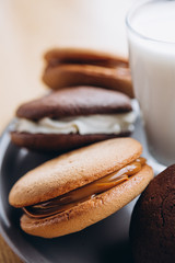 Close up Traditional chocolate and Pumpkin Whoopie pies made with vanilla cream cheese. Background for bakeries, cafes, restaurants
