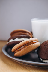 Close up Traditional chocolate and Pumpkin Whoopie pies made with vanilla cream cheese. Background for bakeries, cafes, restaurants
