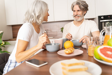 Obraz na płótnie Canvas Happy husband having breakfast with his wife