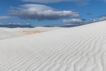 Fototapeta na wymiar Lenticular cloud over white dunes at White Sands National Park in New Mexico