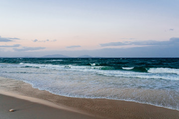 View of an empty tropical beach at sunset
