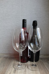 bottle and glass of red wine on wooden table