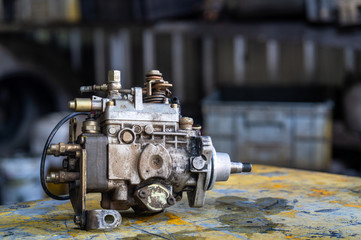 Diesel injection pump on mechanic working table,  mechanical maintenance and repair background