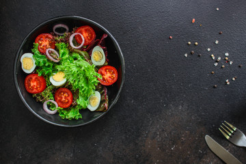 healthy salad vegetables, quail eggs (tomato, lettuce and other ingredients) menu concept. food background. top view. copy space