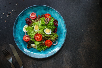 healthy salad vegetables, quail eggs (tomato, lettuce and other ingredients) menu concept. food background. top view. copy space