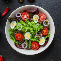 healthy salad vegetables, quail eggs (tomato, lettuce and other ingredients) menu concept. food background. top view. copy space