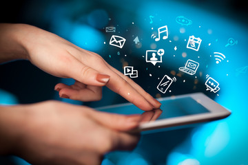 Hand holding tablet with drawn multimedia and application icons