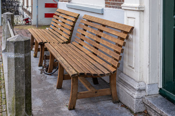 Fototapeta na wymiar Wooden bench on the street of Leiden, Netherlands