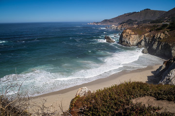 Crashing waves on the beach near Rocky Creek Bridge, California