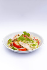 white deep plates with fresh salad ingredients mixed with sauce placed on isolated white background. A place for a menu, banner or advertisement