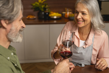 Cheerful middle-aged housewife enjoying her husbands company