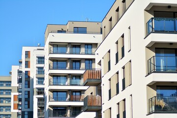 Contemporary residential building exterior in the daylight. Modern apartment buildings on a sunny day with a blue sky. Facade of a modern apartment building