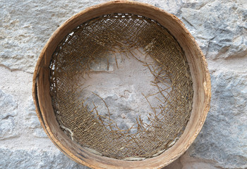 old sieve hanging on wall