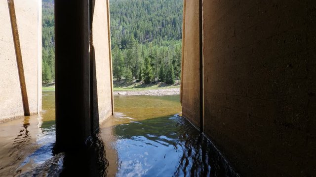Mountain stream being diverted into a concrete tunnel