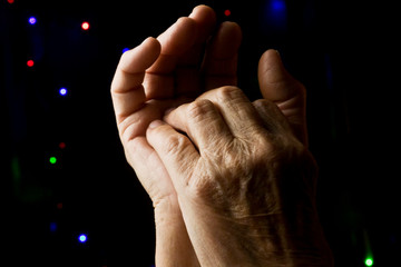 Grandmother's old wrinkled hands close-up. Old palms of mother.