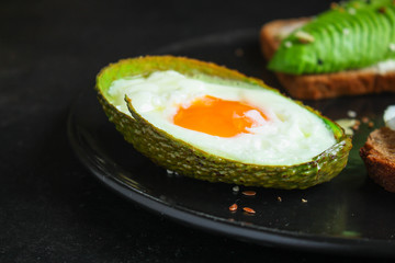 fried eggs in avocado (healthy breakfast, vitamins) menu concept. food background. top view. copy space
