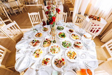  tables setting at a luxury wedding hall. table for guests. dish