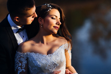 Naklejka premium elegant bride with beautiful makeup and dress with lace. groom i