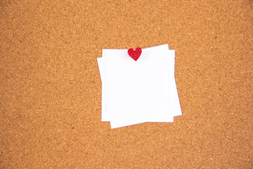 red heart note paper on cork board