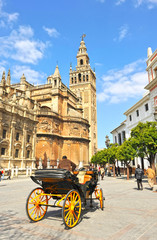 Fototapeta premium Horse carriage in the Seville Cathedral and Giralda Tower, Andalusia, Spain