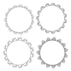 Four round black-and-white frames with suns, clouds and decorative elements. Isolated wreaths on white background for your design
