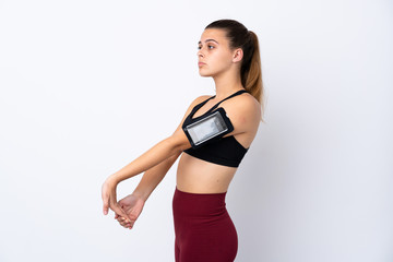 Obraz premium Teenager sport girl over isolated white background stretching