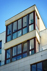 Contemporary residential building exterior in the daylight. Modern apartment buildings on a sunny day with a blue sky. Facade of a modern apartment building
