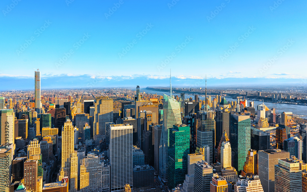 Wall mural Aerial panoramic view. on Midtown district of Manhattan in New York. Hudson river is on the background. Metropolitan City skyline, USA. American architecture building. Panorama of Metropolis NYC