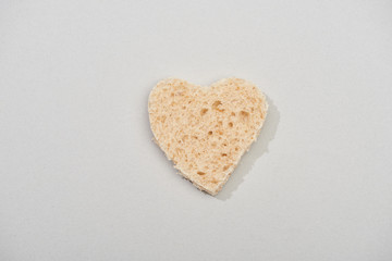 Top view of heart shape from bread on grey background
