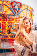 Young happy woman in new year holidays on the background of lights