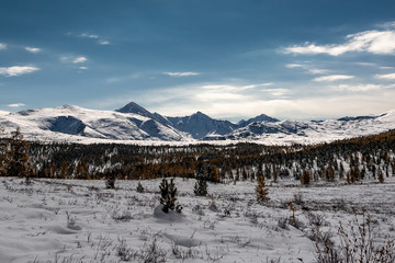 Fototapeta na wymiar Snow covered mountain range lit by the winter sun