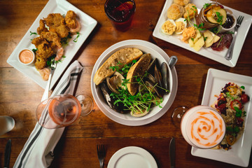 Wooden Table in Restaurant with food and cocktail 
