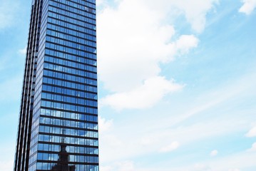 Abstract image of looking up at modern glass and concrete building. Architectural exterior detail of office building. 