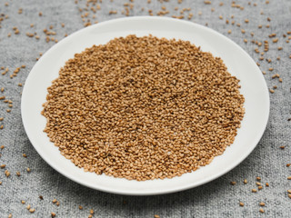 Toasted sesame seeds on white plate