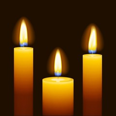 Set of three burning candles