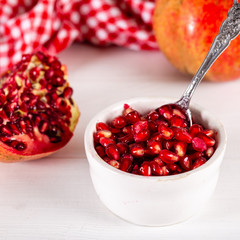 Bowl with pomegranate seeds on table