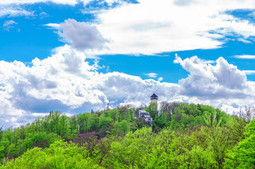 Diana Observation Tower (Rozhledna Diana) and funicular on hill above Slavkov Forest with green...