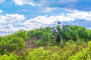 Diana Observation Tower (Rozhledna Diana) and funicular on hill above Slavkov Forest with green...