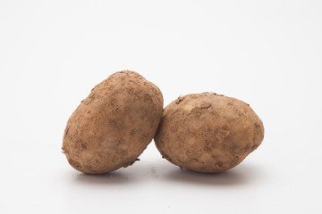Raw potatoes on white 