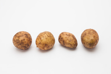Fototapeta premium Row of Potatoes on White Background