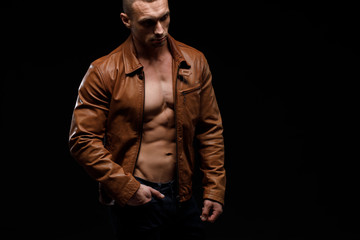 Fototapeta na wymiar Young handsome man, leather jacked on naked torso, emotional posing, lifestyle people concept