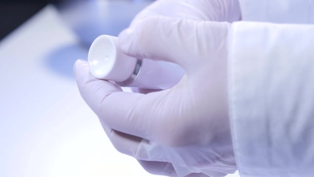 Opening a white tube with ointment 