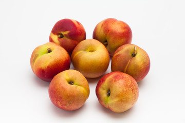 Group of ripe peaches on a white