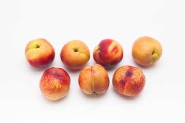 Fototapeta na wymiar Group of ripe peaches on a white